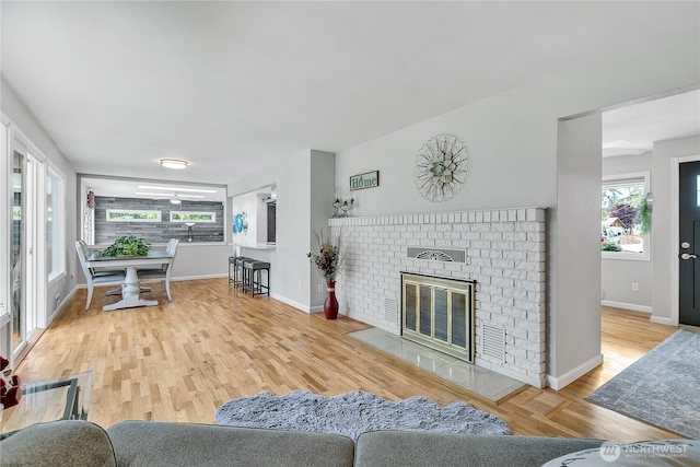 1317 23rd Ave SW, Puyallup, WA 98371 - living room featuring plenty of natural light, wood finished floors, and a brick fireplace