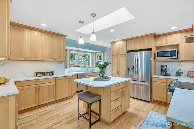 1317 23rd Ave SW, Puyallup, WA 98371 - kitchen featuring stainless steel appliances, light brown cabinets, a skylight, and recessed lighting