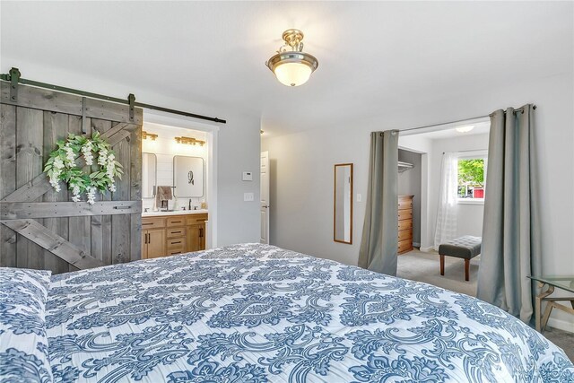 1317 23rd Ave SW, Puyallup, WA 98371 - carpeted bedroom featuring a barn door and ensuite bathroom