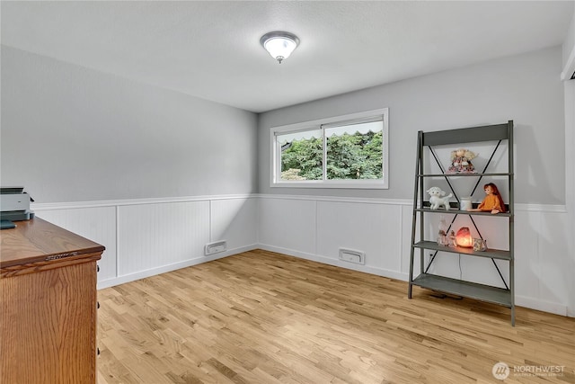 1317 23rd Ave SW, Puyallup, WA 98371 - spare room featuring light wood-type flooring and wainscoting