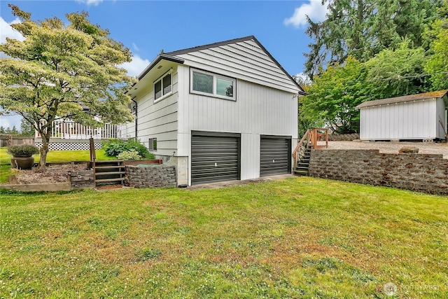 1317 23rd Ave SW, Puyallup, WA 98371 - rear view of property featuring stairs, a garage, a lawn, and a deck