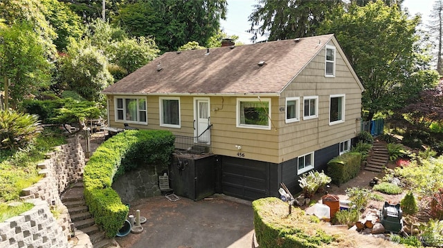 456 Upper Grand Ave, Hoquiam, WA 98550 - view of front of home with stairway, roof with shingles, an attached garage, and asphalt driveway
