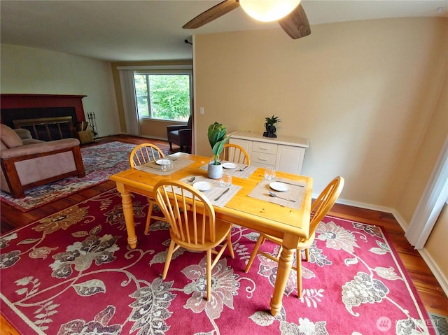 456 Upper Grand Ave, Hoquiam, WA 98550 - dining space featuring wood finished floors, a ceiling fan, and a glass covered fireplace