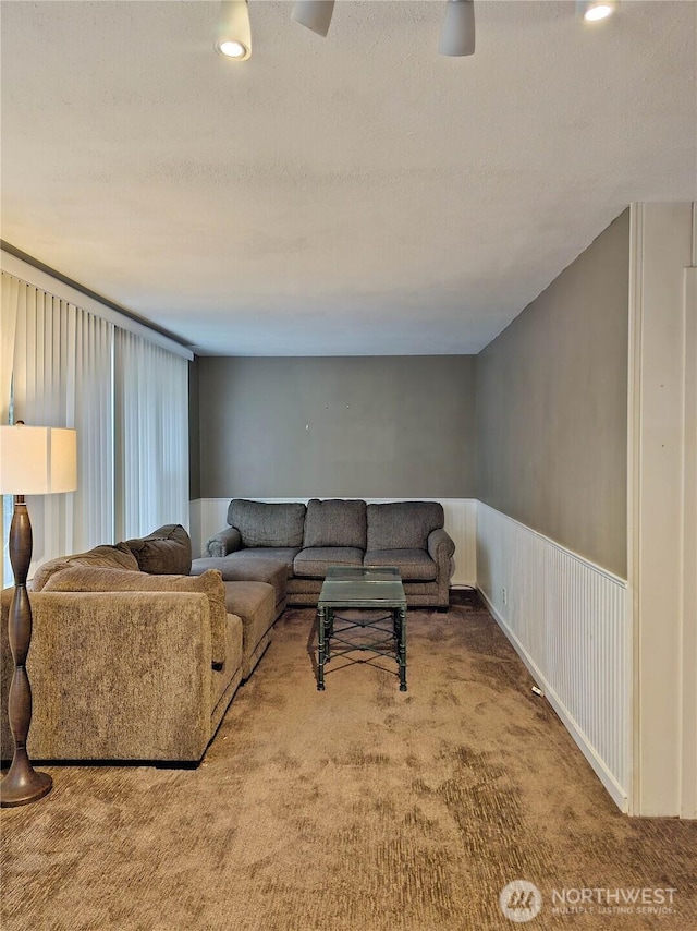 456 Upper Grand Ave, Hoquiam, WA 98550 - living room featuring carpet floors, a wainscoted wall, and a textured ceiling