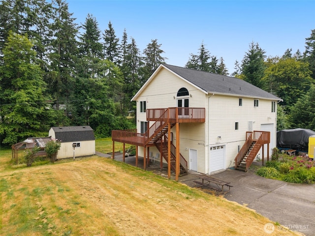 28713 207th Ave SE, Kent, WA 98042 - back of property featuring stairway, a garage, a deck, a storage unit, and driveway