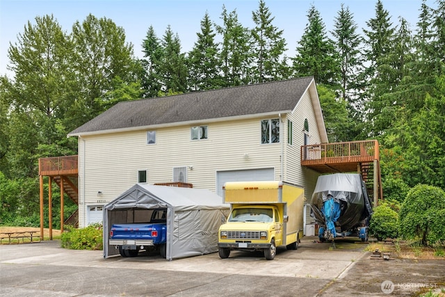 28713 207th Ave SE, Kent, WA 98042 - rear view of house with an attached garage, a wooden deck, and concrete driveway