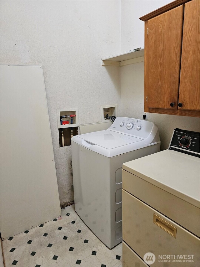 61 Flamingo Rd, Port Townsend, WA 98368 - washroom with washing machine and dryer, light floors, and cabinet space