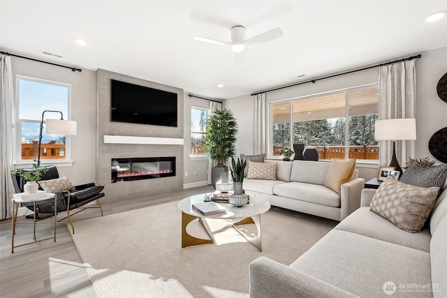 20230 150th St E Unit 598, Bonney Lake, WA 98391 - living room with wood finished floors, a ceiling fan, a large fireplace, and recessed lighting