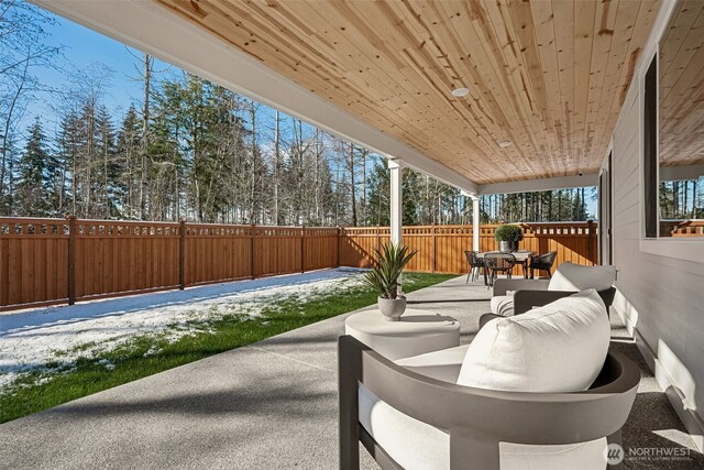 20230 150th St E Unit 598, Bonney Lake, WA 98391 - fenced backyard featuring outdoor dining area, a patio area, and view of wooded area