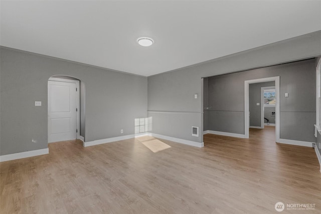 2849 Flordia St, Longview, WA 98632 - empty room with arched walkways and light wood-style flooring