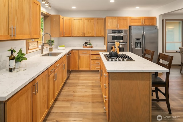 44422 SE 130th St, North Bend, WA 98045 - kitchen with appliances with stainless steel finishes, a breakfast bar, light wood-type flooring, a center island, and recessed lighting