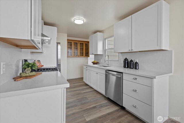 5717 S Ryan St, Seattle, WA 98178 - kitchen featuring dishwasher, light wood finished floors, range hood, and white cabinets