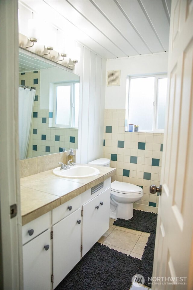 13814 C St S, Tacoma, WA 98444 - bathroom with tile walls, tile patterned flooring, vanity, and curtained shower