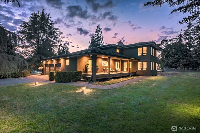 16825 SE 376th St, Auburn, WA 98092 - back of property at dusk featuring an attached garage, driveway, and a chimney