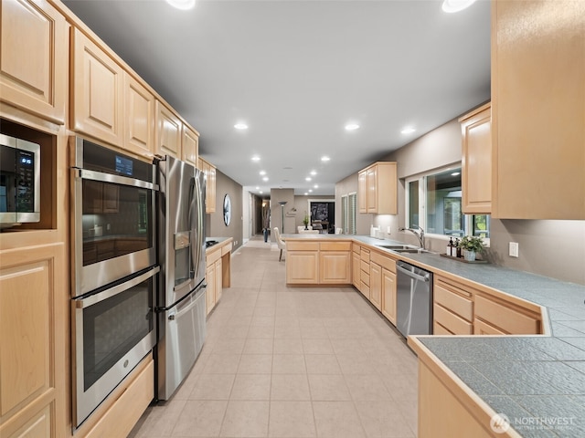 16825 SE 376th St, Auburn, WA 98092 - kitchen featuring light brown cabinets, appliances with stainless steel finishes, a peninsula, light tile patterned floors, and recessed lighting