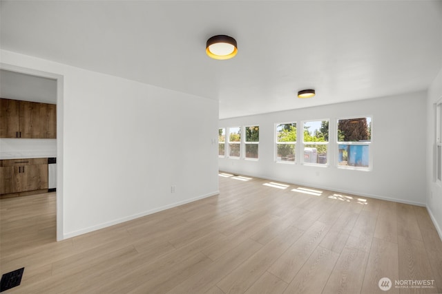 24222 54th Ave W Unit 55, Mountlake Terrace, WA 98043 - unfurnished living room featuring light wood-style floors and baseboards