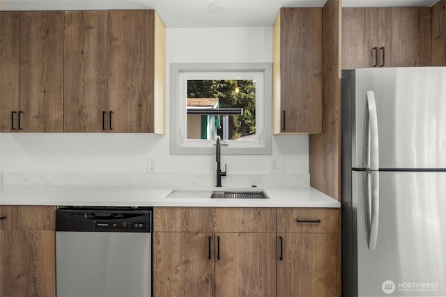 24222 54th Ave W Unit 55, Mountlake Terrace, WA 98043 - kitchen with stainless steel appliances, light countertops, brown cabinetry, and modern cabinets