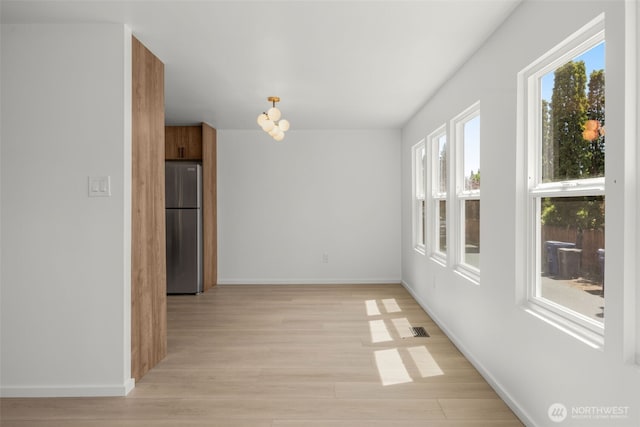 24222 54th Ave W Unit 55, Mountlake Terrace, WA 98043 - unfurnished dining area with light wood-style floors and baseboards