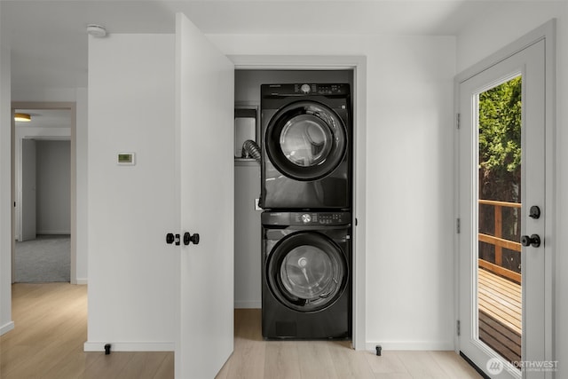 24222 54th Ave W Unit 55, Mountlake Terrace, WA 98043 - laundry room with stacked washing machine and dryer and light wood finished floors