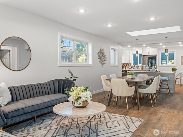 4853 42nd Ave SW, Seattle, WA 98116 - living area featuring wood finished floors, a skylight, and recessed lighting