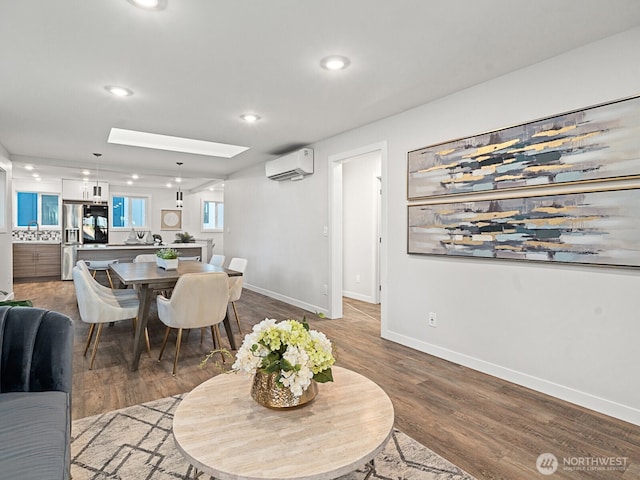 4853 42nd Ave SW, Seattle, WA 98116 - dining space featuring wood finished floors, a wall mounted air conditioner, recessed lighting, and a skylight