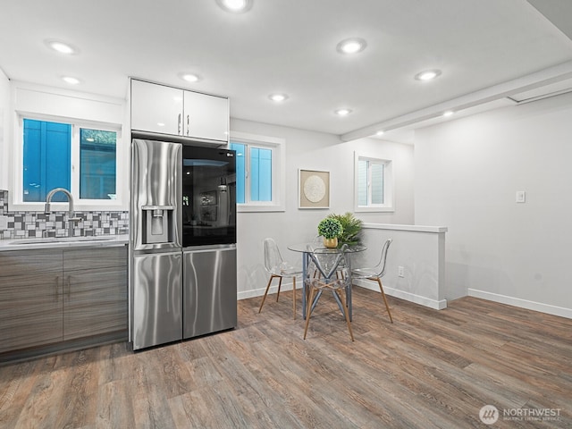 4853 42nd Ave SW, Seattle, WA 98116 - kitchen featuring stainless steel fridge, wood finished floors, tasteful backsplash, modern cabinets, and recessed lighting