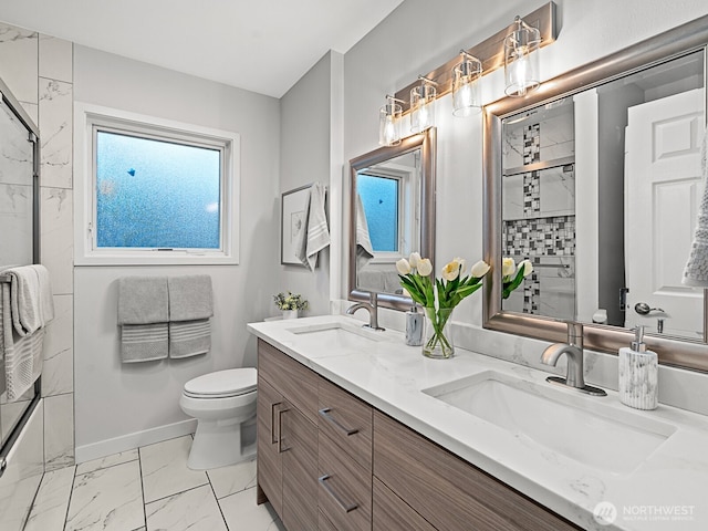 4853 42nd Ave SW, Seattle, WA 98116 - bathroom with double vanity, marble look tiles, and a shower with shower door