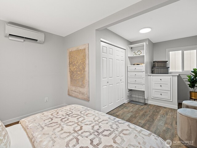 4853 42nd Ave SW, Seattle, WA 98116 - bedroom featuring a wall mounted AC, dark wood finished floors, and a closet