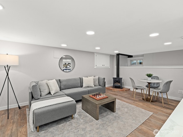 4853 42nd Ave SW, Seattle, WA 98116 - living room featuring a wood stove, recessed lighting, and light wood-style flooring