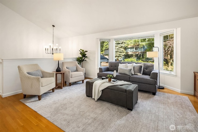 10733 126th Pl NE, Kirkland, WA 98033 - living room featuring a chandelier, wood finished floors, and lofted ceiling