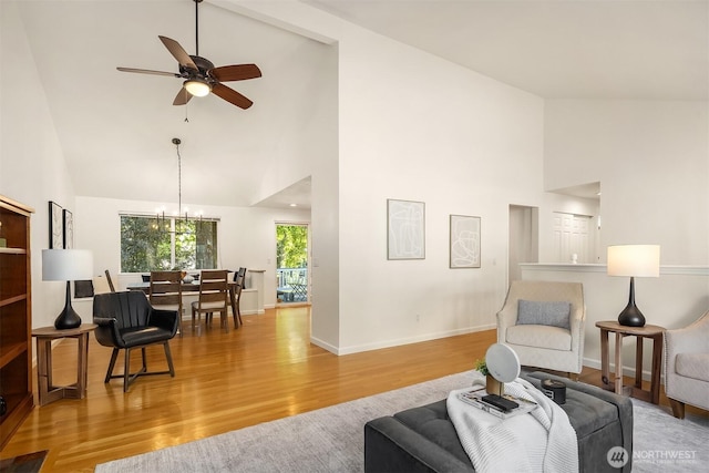 10733 126th Pl NE, Kirkland, WA 98033 - living area with high vaulted ceiling, wood finished floors, a chandelier, and a ceiling fan
