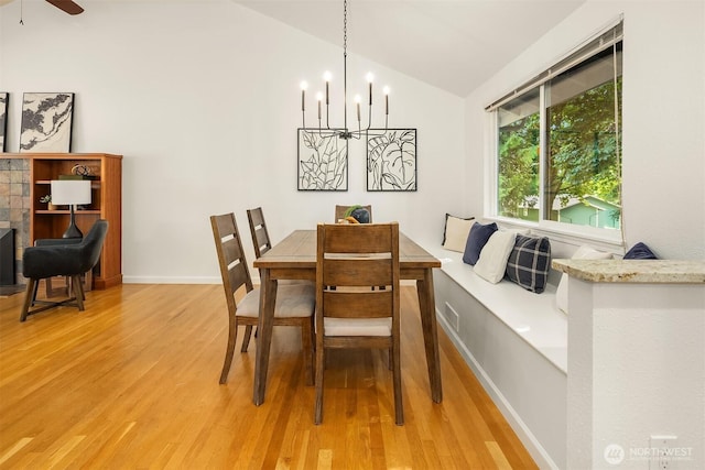 10733 126th Pl NE, Kirkland, WA 98033 - dining room with light wood finished floors, lofted ceiling, a chandelier, and ceiling fan