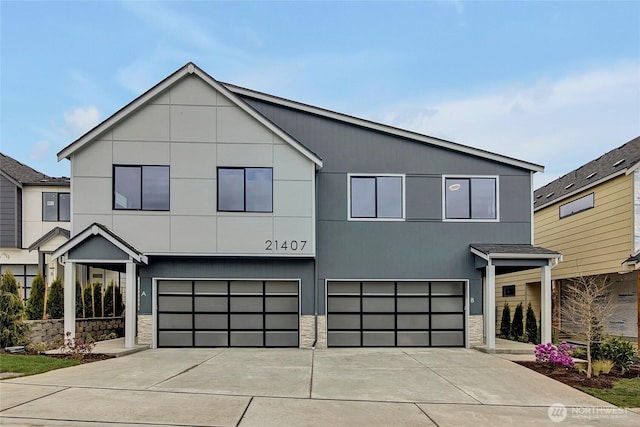 21407 39th Dr SE Unit A, Bothell, WA 98021 - modern home with an attached garage, concrete driveway, and stone siding