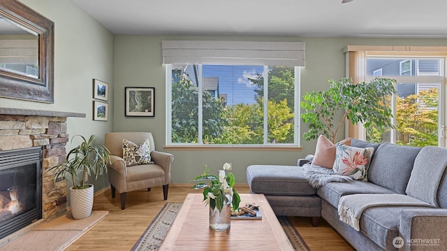 4422 NE 2nd Ln, Renton, WA 98059 - living room with wood finished floors and a stone fireplace