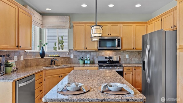 4422 NE 2nd Ln, Renton, WA 98059 - kitchen featuring stainless steel appliances, a kitchen island, light brown cabinetry, light stone countertops, and decorative backsplash