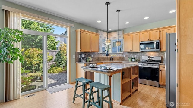 4422 NE 2nd Ln, Renton, WA 98059 - kitchen with stainless steel appliances, light wood-type flooring, tasteful backsplash, open shelves, and recessed lighting