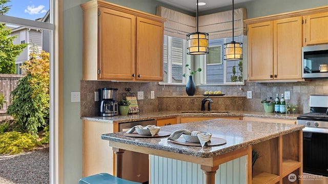 4422 NE 2nd Ln, Renton, WA 98059 - kitchen featuring stainless steel appliances, decorative backsplash, hanging light fixtures, light stone countertops, and a kitchen island