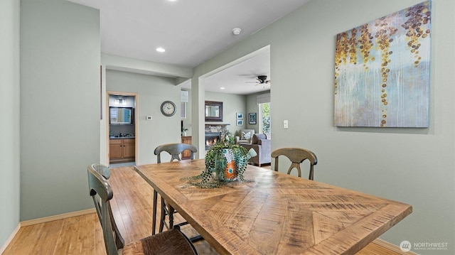 4422 NE 2nd Ln, Renton, WA 98059 - dining area with a warm lit fireplace, recessed lighting, wood finished floors, and a ceiling fan