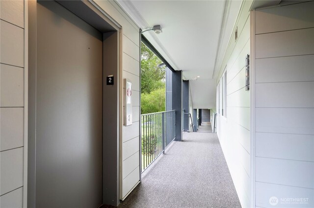 9201 NE Juanita Dr Unit 205, Kirkland, WA 98034 - hallway featuring elevator and carpet flooring