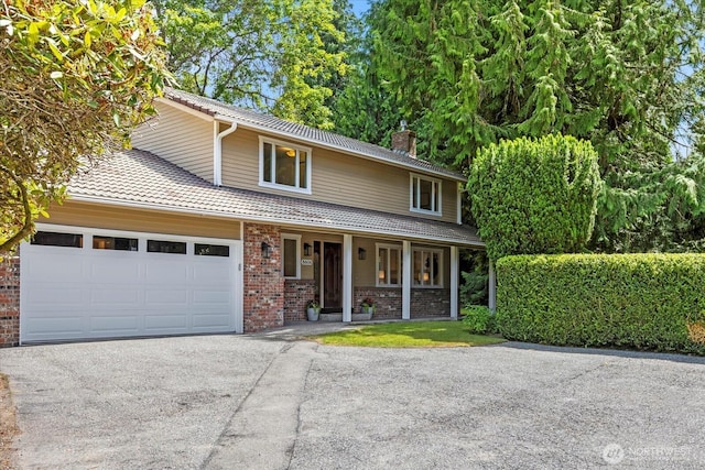 8606 184th St SW, Edmonds, WA 98026 - view of front of house featuring a chimney, covered porch, brick siding, driveway, and an attached garage