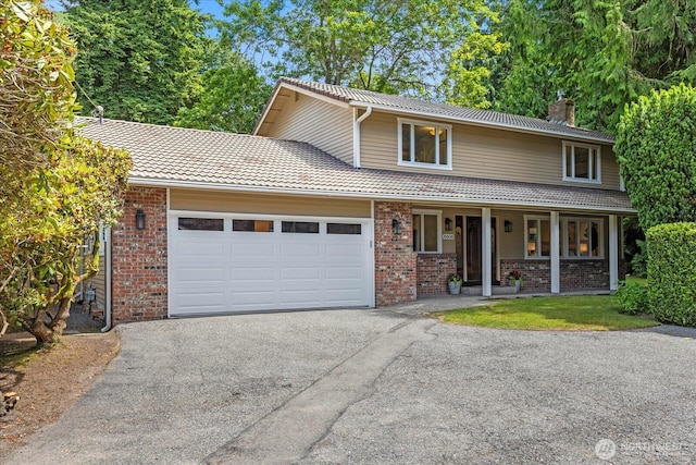 8606 184th St SW, Edmonds, WA 98026 - traditional-style house with a chimney, driveway, brick siding, and a garage