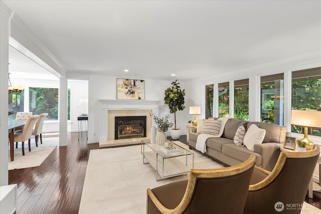 8606 184th St SW, Edmonds, WA 98026 - living room featuring healthy amount of natural light, dark wood-style flooring, a lit fireplace, recessed lighting, and ornamental molding