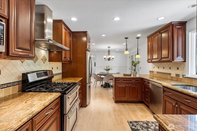 8606 184th St SW, Edmonds, WA 98026 - kitchen with stainless steel appliances, wall chimney exhaust hood, light wood-style floors, tasteful backsplash, and light stone countertops