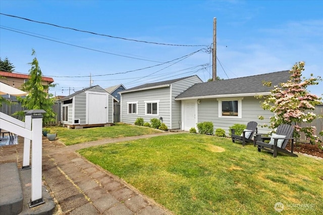751 S 40th St, Tacoma, WA 98418 - back of house with a storage shed and roof with shingles