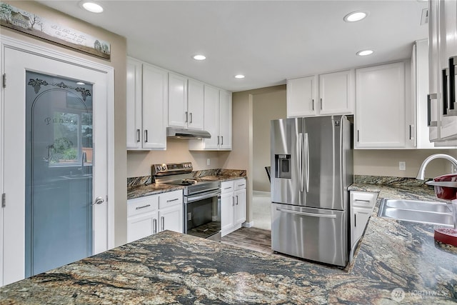 10125 232nd Ave E, Buckley, WA 98321 - kitchen featuring stainless steel appliances, under cabinet range hood, recessed lighting, white cabinetry, and dark stone countertops
