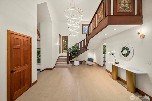 13710 41st Ave NE, Seattle, WA 98125 - foyer featuring light wood-style flooring, plenty of natural light, stairs, a towering ceiling, and a chandelier