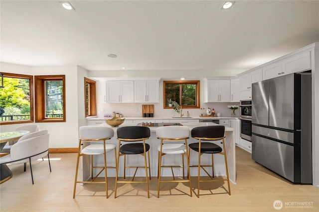 13710 41st Ave NE, Seattle, WA 98125 - kitchen with stainless steel appliances, light countertops, a kitchen island, white cabinets, and recessed lighting