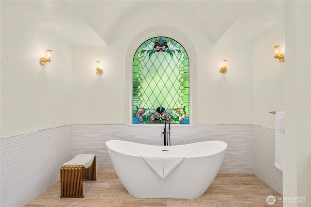 13710 41st Ave NE, Seattle, WA 98125 - bathroom featuring tile walls, a soaking tub, and a wainscoted wall