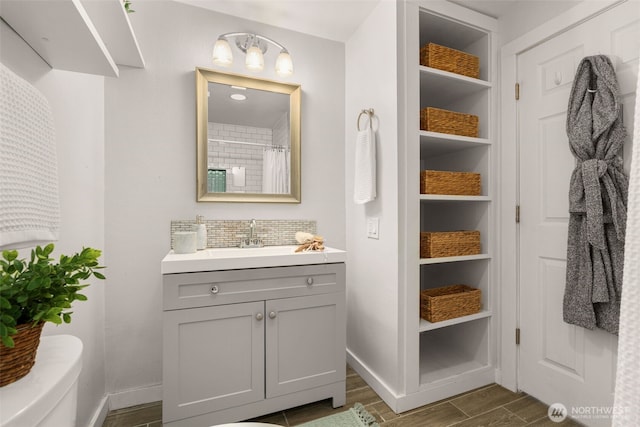 2219 Eastlake Ave E Unit 101, Seattle, WA 98102 - full bath with vanity, wood finished floors, tasteful backsplash, and a shower with shower curtain