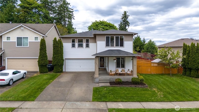 1344 Foreman Rd, Dupont, WA 98327 - view of front facade featuring covered porch, a garage, concrete driveway, and board and batten siding
